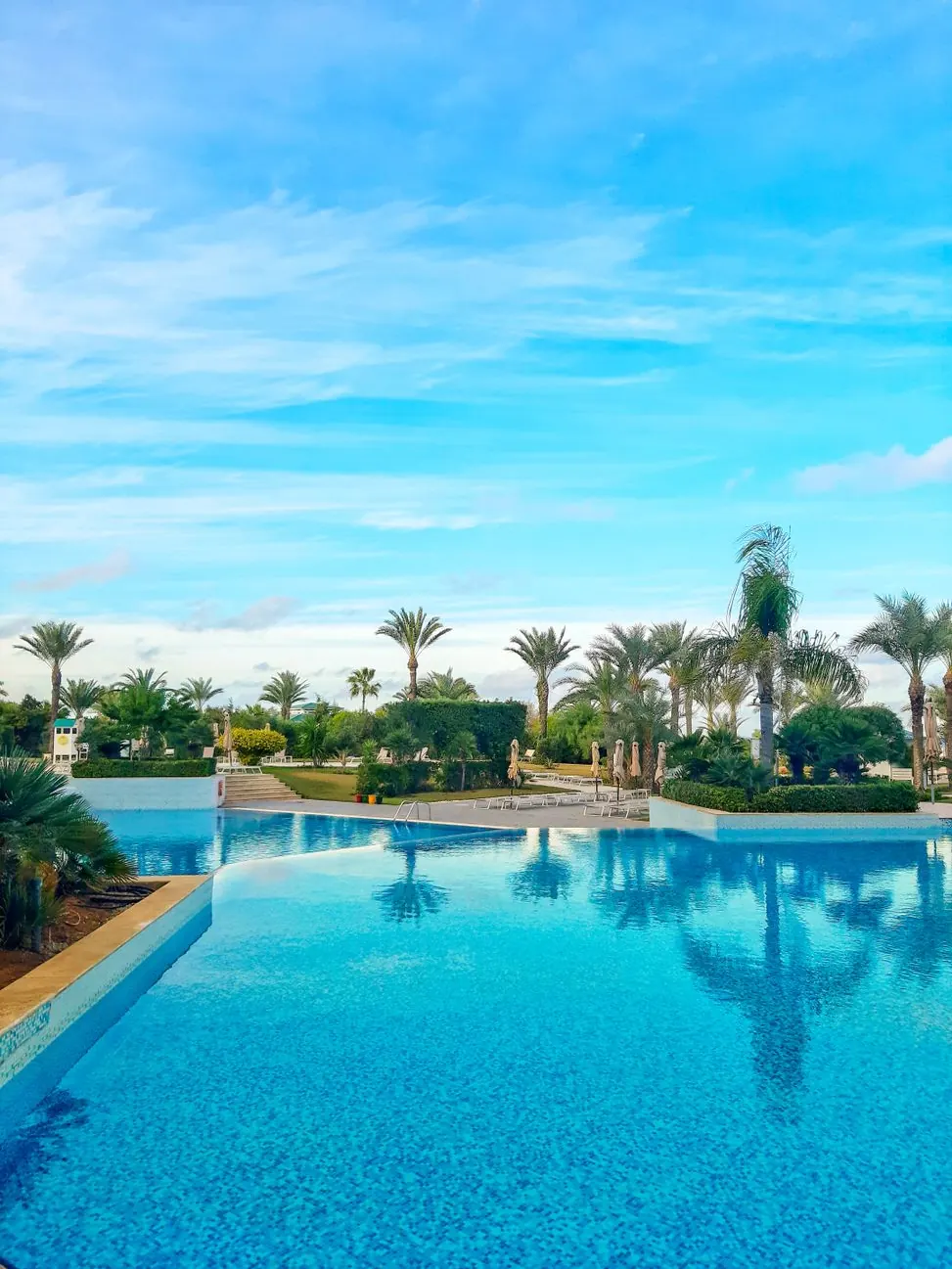 Aerial view of a wedding villa with pool and palm garden in the Palmeraie