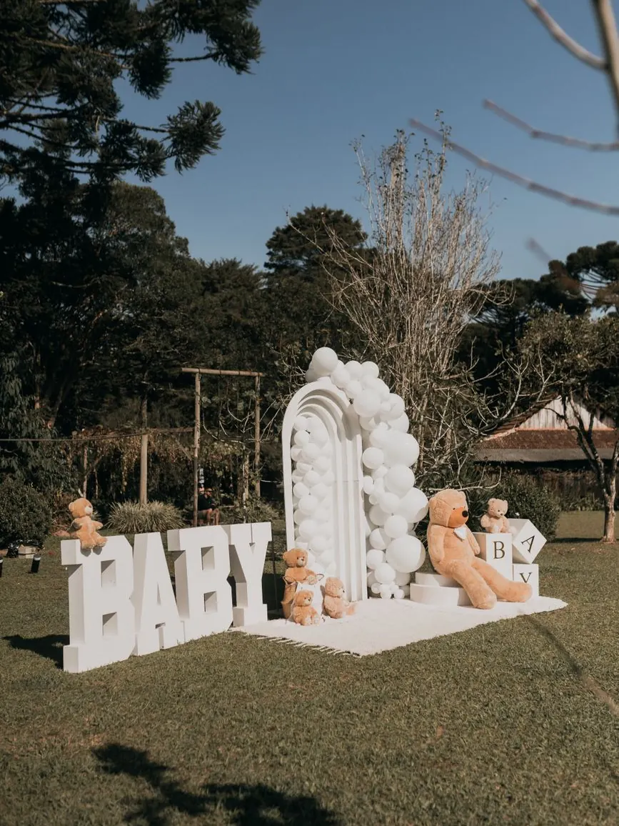 Balloon arch and flower-dressed sweet table for a baby shower in a riad garden