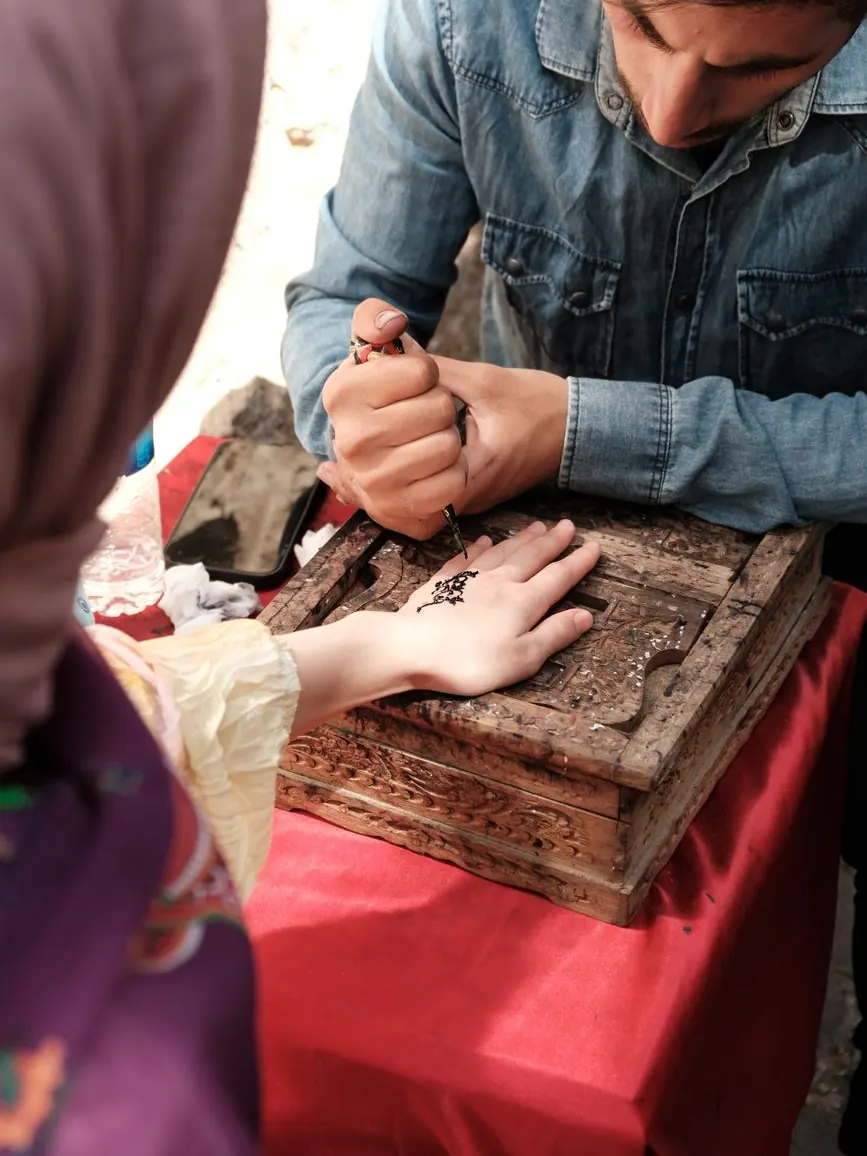 Bride's hands decorated with henna during a traditional Moroccan henna night