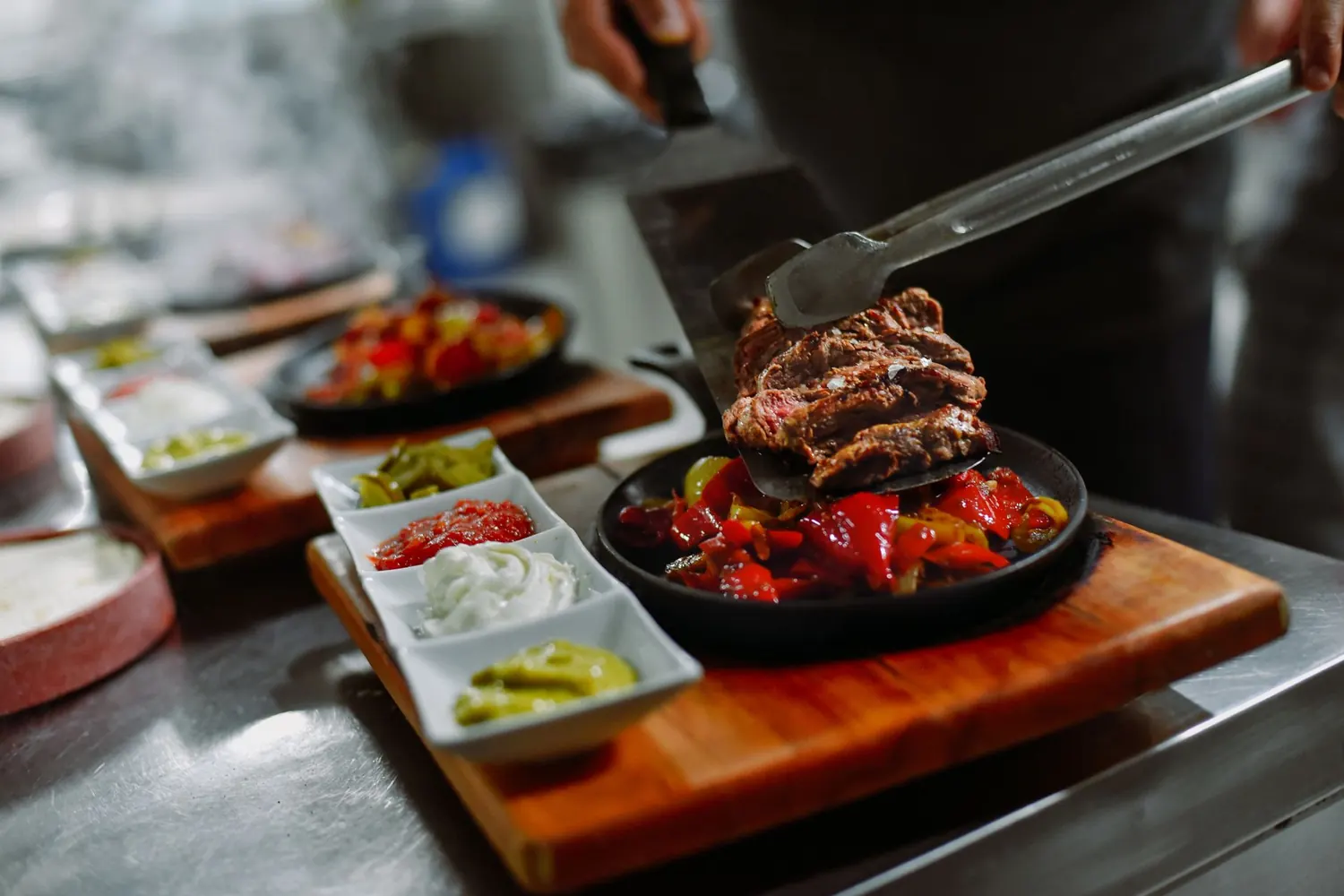 Chef carving roast meat at a live cooking station during a Moroccan wedding