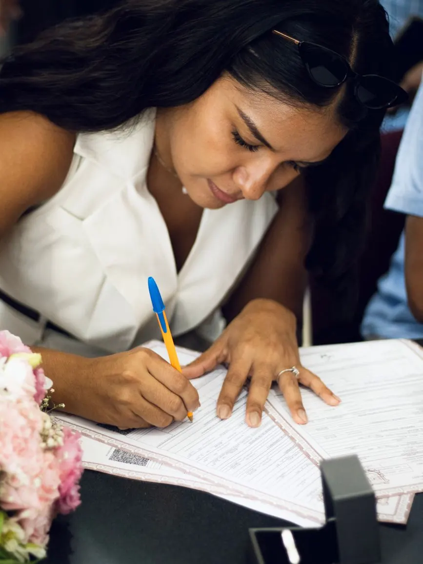 Couple signing their marriage certificate before witnesses in Morocco