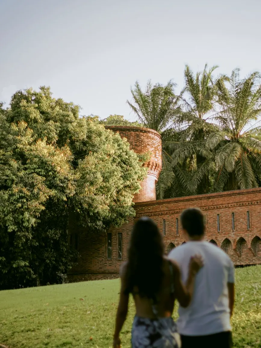 Couple walking through a Marrakech villa garden with their wedding planner