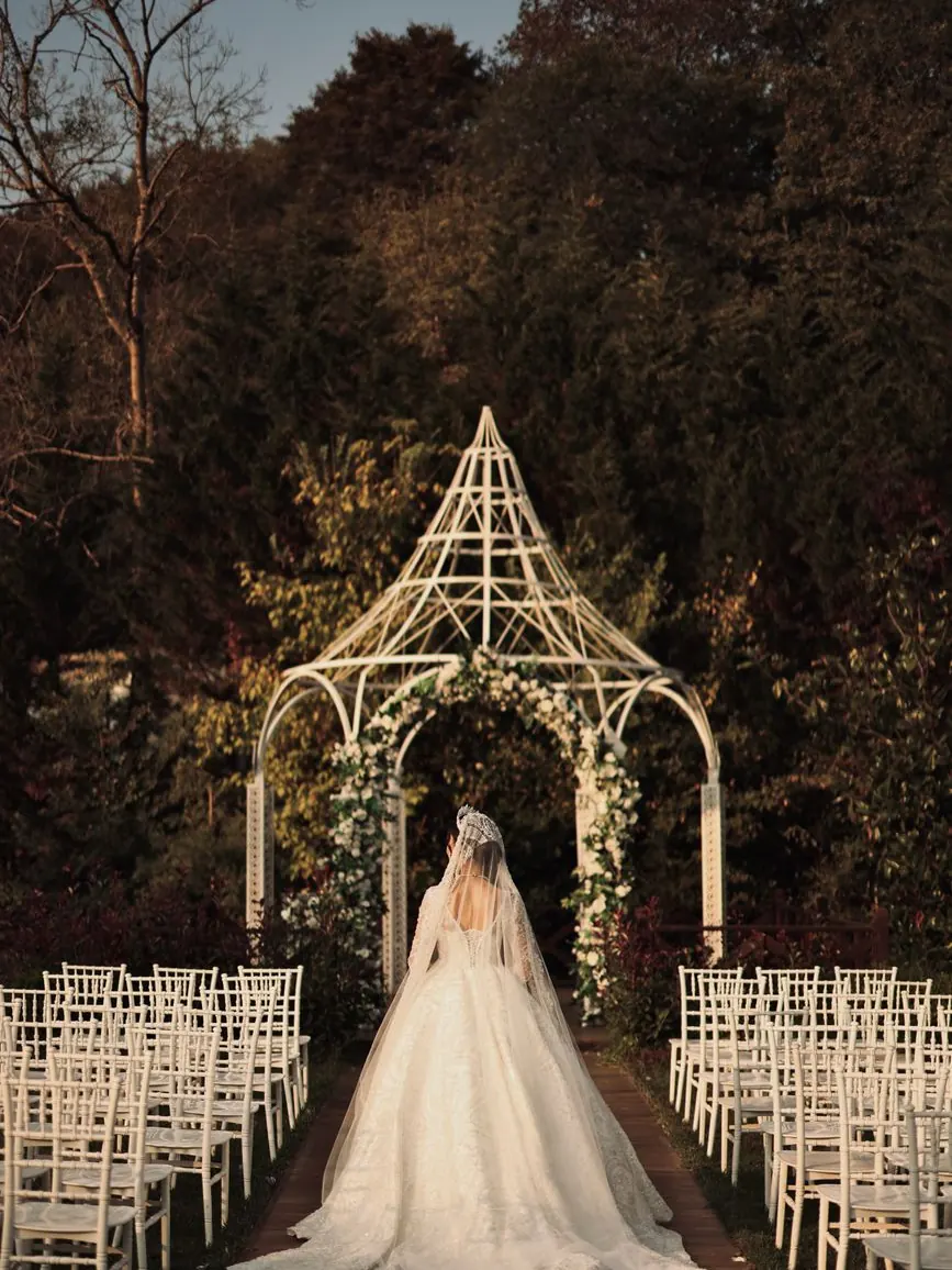 Ivory floral arch set for a wedding ceremony in a Marrakech villa garden